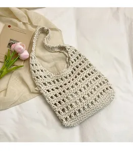 Detail of woven tote bag with hollow check pattern and neutral beige fabric lining