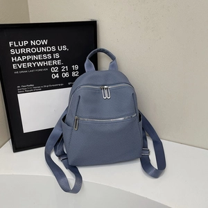 Modern light blue woven texture backpack with multiple pockets for daily commuting