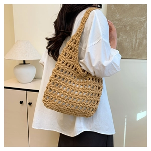 Detail of a handmade crochet tote bag in khaki showing large hollow weave pattern