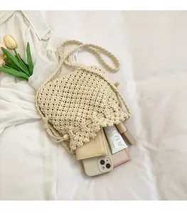 Detail view of woven shoulder bag showing spacious interior for phone and cosmetics
