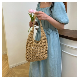 Detail showing the woven texture and large hollow mesh design of the handmade knit bag