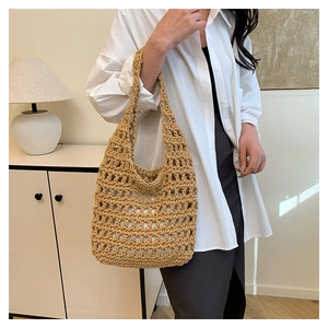 Close-up of khaki handmade woven shoulder bag with large mesh hollow knit design