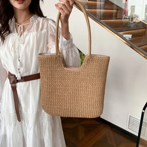 Handwoven straw tote bag with integrated handles for women in natural beige color