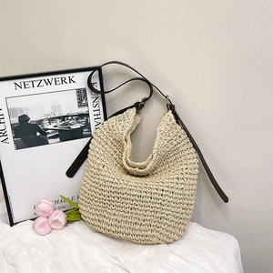 Large woven hobo bag with brown leather strap and minimalist bohemian design for women