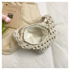 Detail of cream woven handbag with mesh texture and tulip decor in a lifestyle setting