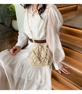 Detail of hand-woven bucket bag with drawstring closure and braided shoulder strap