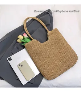 Handwoven straw tote bag shown with an iPad and smartphone to display interior capacity