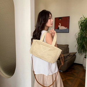 Chic beige woven straw tote bag with a triangle pattern and leather shoulder straps