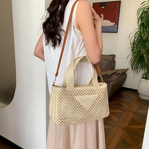 Beige woven straw shoulder bag with leather strap and hollow crochet design for summer