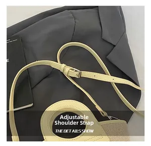 Detail of adjustable beige shoulder strap with silver metal buckle on mesh shell bag
