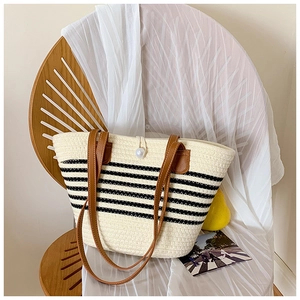 Large cream woven straw tote bag with black stripes, pearl closure and leather handles