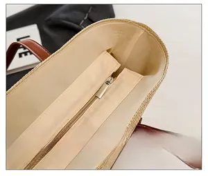 Close-up of smooth metal zipper and beige lining on large straw beach tote bag