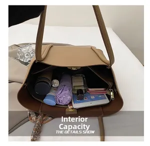 Detail showing spacious interior capacity of khaki tote bag with daily essentials inside