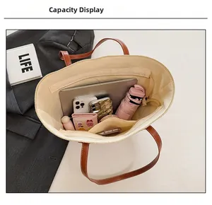 Interior capacity of large straw tote bag showing compartments and daily essentials