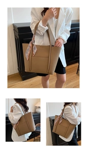 Close-up of khaki pebbled leather tote bag featuring stylish floral scarf detail on handle