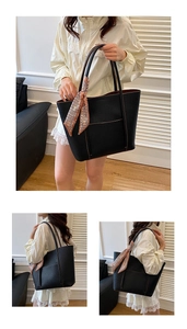 Close-up of black pebble leather tote bag with brown interior and decorative scarf