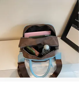 Interior view of large capacity two-tone travel bag showing storage for tablet and umbrella