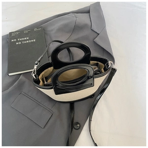 Internal detail of a minimalist canvas and leather shell bag with zipper pocket