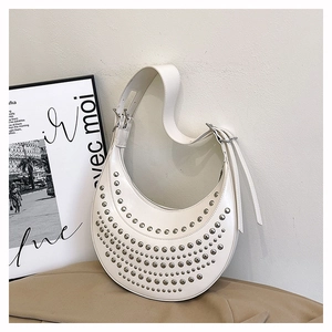 White faux leather crescent bag with silver rivet studs and adjustable shoulder strap