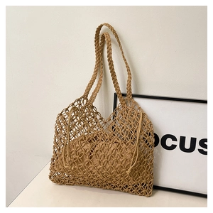 Detail of hand-woven hollow mesh tote bag with matching drawstring inner liner pouch