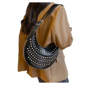 Black crescent rivet shoulder bag with silver studs and adjustable strap in Y2K style