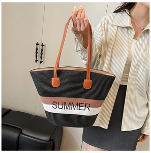 Detail of striped straw tote with Summer embroidery and durable leather handles