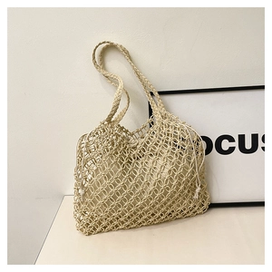 Detail of beige woven mesh handbag with inner canvas pouch and drawstring closure