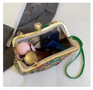 Top view of floral embroidery evening bag showing spacious interior with pearl clasp