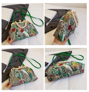 Close-up of floral print crossbody bag featuring pearl handle and metal clasp closure