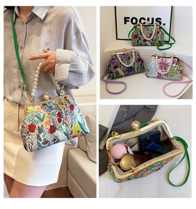 Detail of floral frame bag with pearl handle and spacious interior for daily essentials