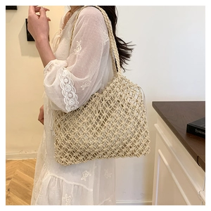 Close-up of beige hollow woven tote bag with mesh pattern and matching inner fabric pouch