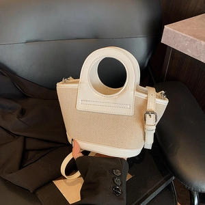 White leather and beige woven shell bag with circular cutout handle and slim strap