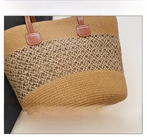 Detail of two-tone woven straw tote bag with hollow diamond pattern and leather accents
