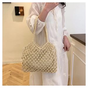 Detail of hand-woven beige mesh tote bag with a white drawstring inner pouch