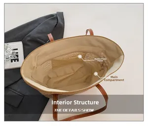 Detail view of straw tote bag interior with fabric lining, phone pocket and main compartment