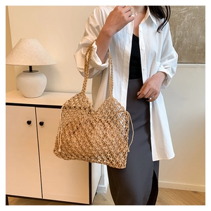Detail of woven straw tote bag with grid texture and drawstring inner pouch