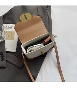 Top view of contrast color crossbody bag showing interior space for phone and lipstick