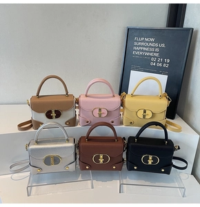 Detail showing various colors of lychee grain leather mini bags with gold oval metal locks