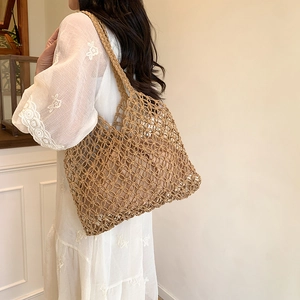 Handmade woven jute shoulder bag with internal liner and open mesh design for women