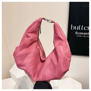 Close-up of bright pink hobo bag featuring soft pleated leather and silver hardware details