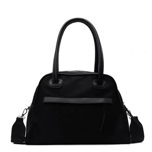Minimalist black nylon tote bag with leather trim and detachable shoulder strap