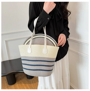 Matching straw tote bag and sun hat set with navy stripes and white leather handles