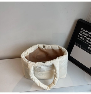 Detailed interior of quilted tote bag featuring a magnetic clasp and large storage space