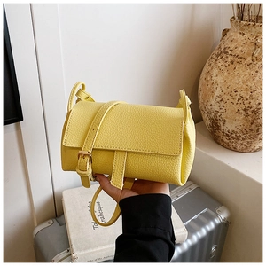 Detail of yellow lychee pattern leather crossbody bag with adjustable gold buckle