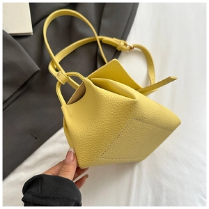 Detailed close-up of yellow litchi pattern leather shoulder bag with adjustable strap