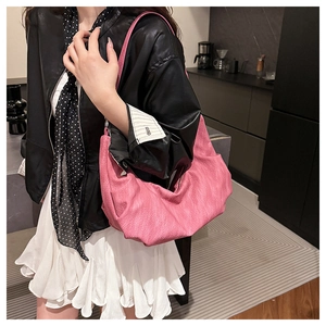 Detail of pink soft pebble leather shoulder bag showing large capacity and natural texture
