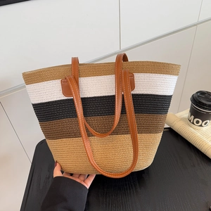 Striped straw tote bag with multi-color weave and leather handles for beach vacation