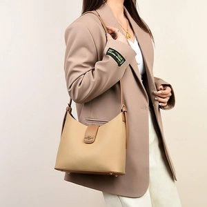 Detail view of large capacity beige leather hobo bag with textured lychee grain