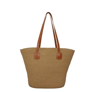 Large straw tote bag with brown leather handles for summer beach vacations