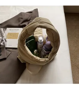 Detailed interior of beige quilted tote bag showing spacious storage for daily items